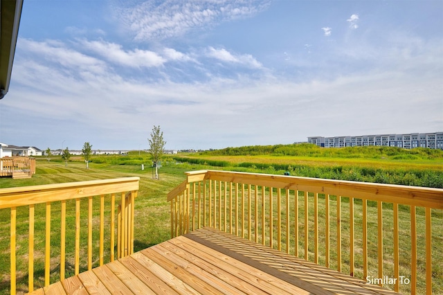 wooden deck featuring a yard