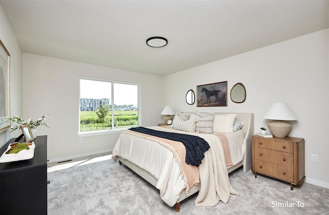 carpeted bedroom with a textured ceiling