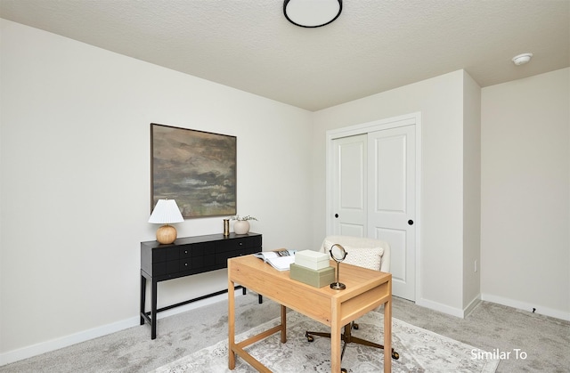 carpeted office with a textured ceiling