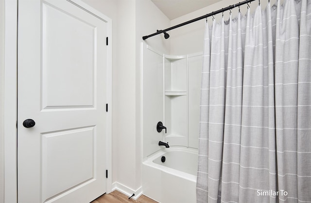 bathroom featuring shower / tub combo with curtain and hardwood / wood-style floors