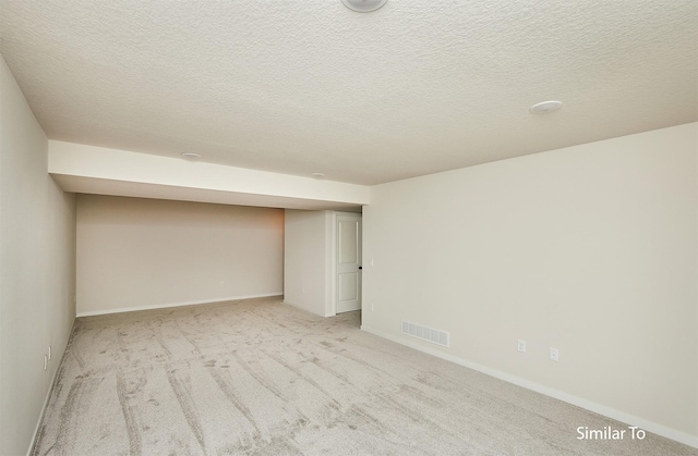 unfurnished bedroom with light carpet and a textured ceiling