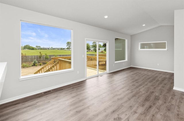 6423 NE 11th Ct, Des Moines, IA 50313 - spare room featuring wood finished floors, lofted ceiling, baseboards, and recessed lighting