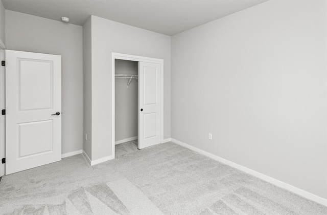 6423 NE 11th Ct, Des Moines, IA 50313 - unfurnished bedroom with carpet flooring, a closet, and baseboards