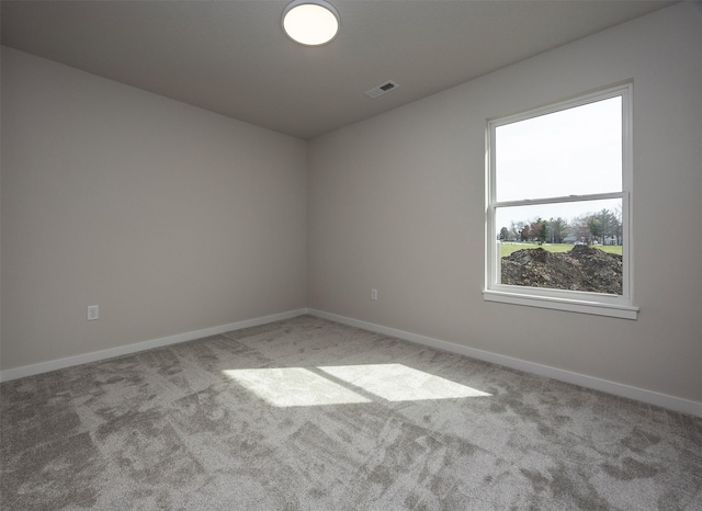 spare room featuring baseboards, carpet flooring, and visible vents