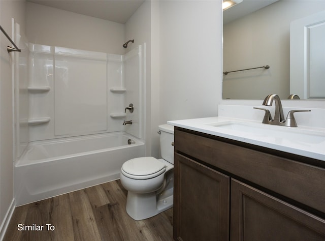 bathroom with vanity, shower / washtub combination, wood finished floors, and toilet