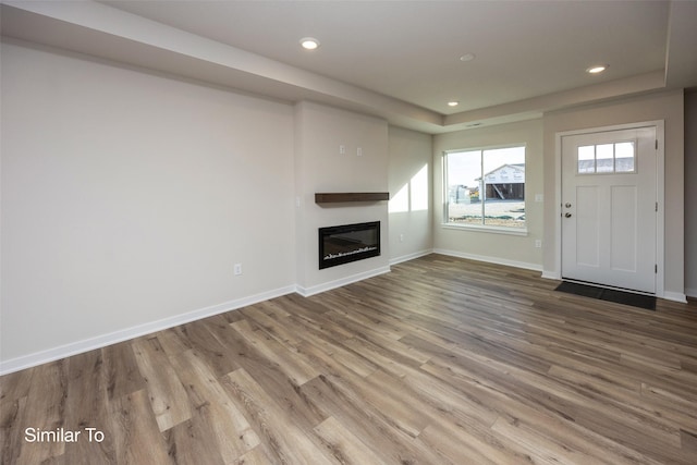 unfurnished living room with hardwood / wood-style floors