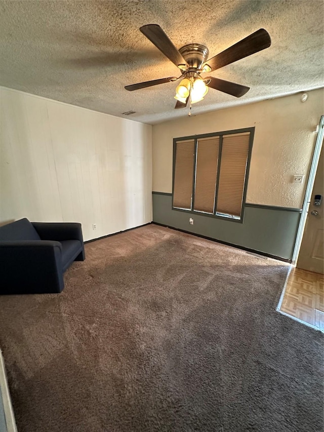 interior space with ceiling fan and a textured ceiling