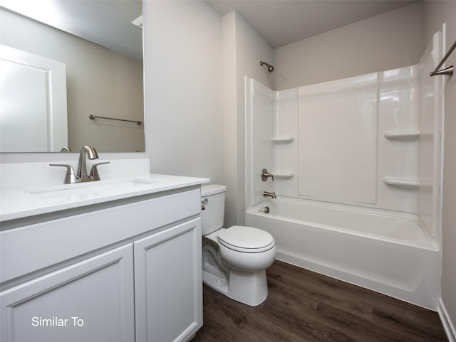 full bathroom featuring wood-type flooring, shower / washtub combination, vanity, and toilet