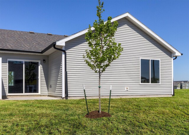 2228 Legacy Dr, Norwalk, IA 50211 - back of house with a lawn, a shingled roof, and a patio