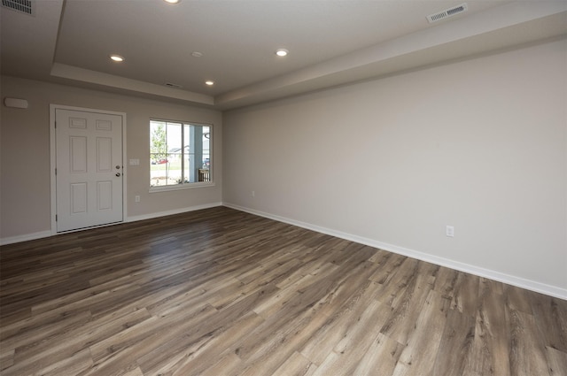 2228 Legacy Dr, Norwalk, IA 50211 - spare room featuring a raised ceiling, wood finished floors, recessed lighting, and baseboards