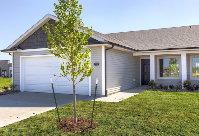 2232 Legacy Dr, Norwalk, IA 50211 - ranch-style house featuring an attached garage, a front lawn, driveway, and roof with shingles
