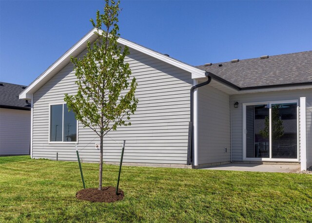 2232 Legacy Dr, Norwalk, IA 50211 - view of home's exterior featuring a lawn and roof with shingles