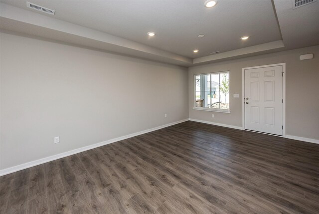 2232 Legacy Dr, Norwalk, IA 50211 - empty room featuring a raised ceiling, baseboards, dark wood-style flooring, and recessed lighting