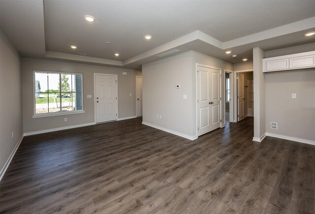 2232 Legacy Dr, Norwalk, IA 50211 - empty room featuring baseboards, dark wood-type flooring, recessed lighting, and a tray ceiling