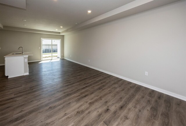 2232 Legacy Dr, Norwalk, IA 50211 - unfurnished living room featuring a sink, baseboards, dark wood finished floors, and recessed lighting