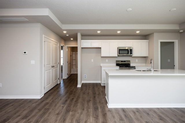 2232 Legacy Dr, Norwalk, IA 50211 - kitchen featuring appliances with stainless steel finishes, a sink, dark wood-style flooring, baseboards, and white cabinets