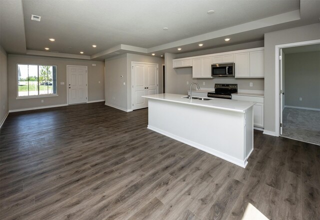 2232 Legacy Dr, Norwalk, IA 50211 - kitchen featuring appliances with stainless steel finishes, a raised ceiling, a sink, white cabinetry, and baseboards