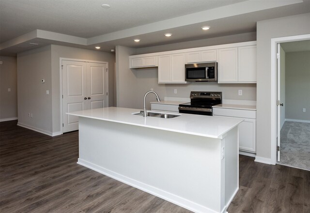 2232 Legacy Dr, Norwalk, IA 50211 - kitchen with appliances with stainless steel finishes, a sink, white cabinets, dark wood-type flooring, and baseboards