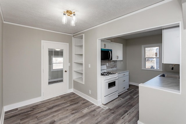 kitchen with sink, white range with gas stovetop, white cabinetry, ornamental molding, and dark hardwood / wood-style flooring