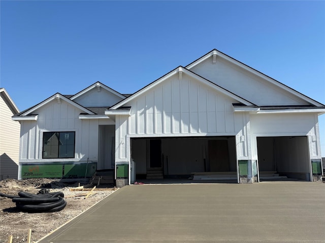 modern farmhouse style home with board and batten siding, an attached garage, and entry steps