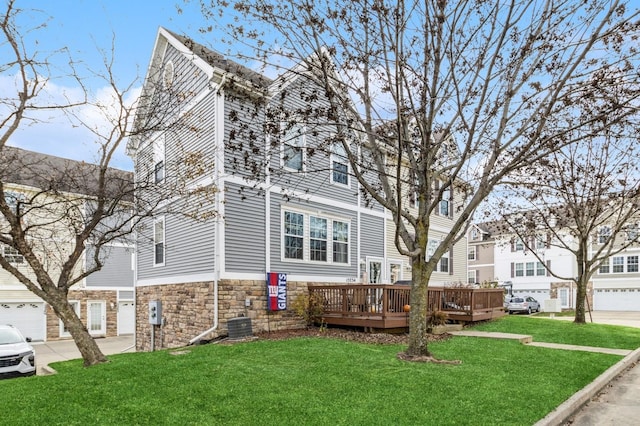 view of front of property with a deck and a front lawn