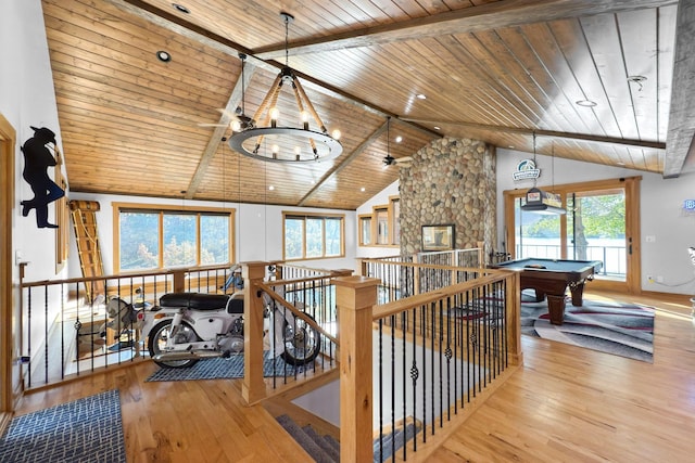 interior space featuring a notable chandelier, plenty of natural light, wooden ceiling, and light hardwood / wood-style floors