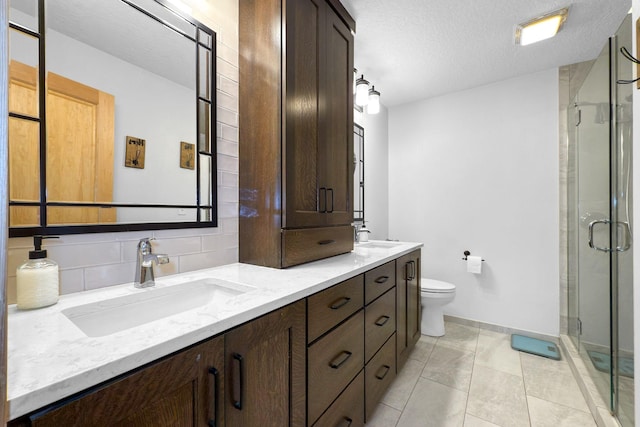 bathroom with vanity, a textured ceiling, decorative backsplash, toilet, and walk in shower