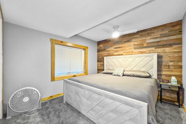 bedroom featuring wood walls and carpet