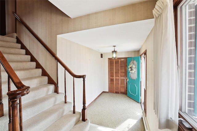 view of carpeted foyer entrance