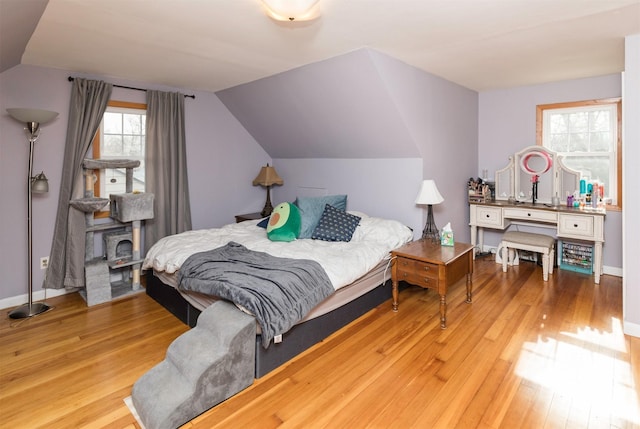 bedroom featuring vaulted ceiling and light hardwood / wood-style floors