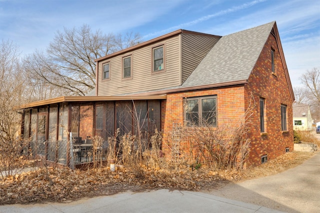 view of property exterior featuring a sunroom