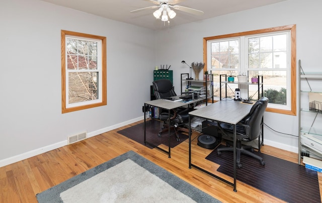 office with hardwood / wood-style floors and ceiling fan