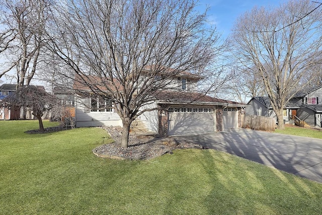 view of front of home featuring a garage and a front yard