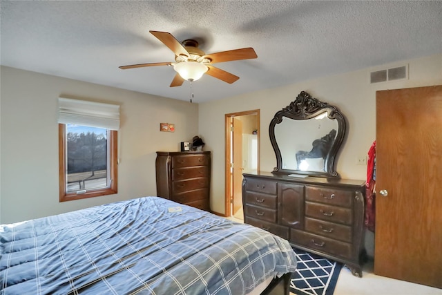 bedroom featuring ceiling fan and a textured ceiling