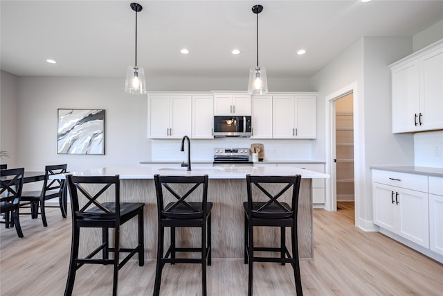 4632 179th St, Urbandale, IA 50323 - kitchen featuring appliances with stainless steel finishes, light countertops, light wood-style floors, decorative backsplash, and recessed lighting