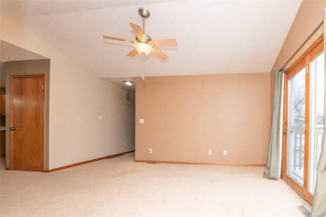 unfurnished room with light carpet, lofted ceiling, and ceiling fan