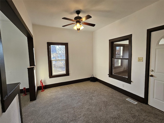 carpeted foyer entrance with ceiling fan