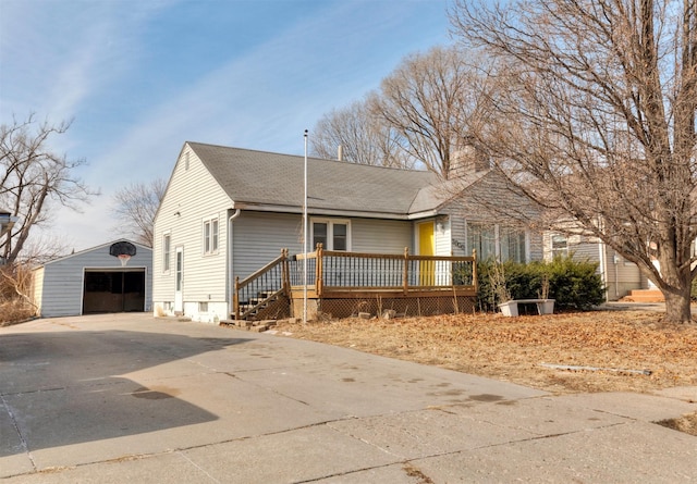 view of front of property featuring a garage, an outdoor structure, and a deck