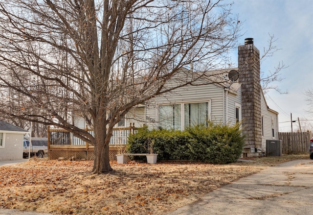 view of property exterior featuring a wooden deck