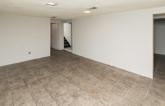 spare room with a textured ceiling