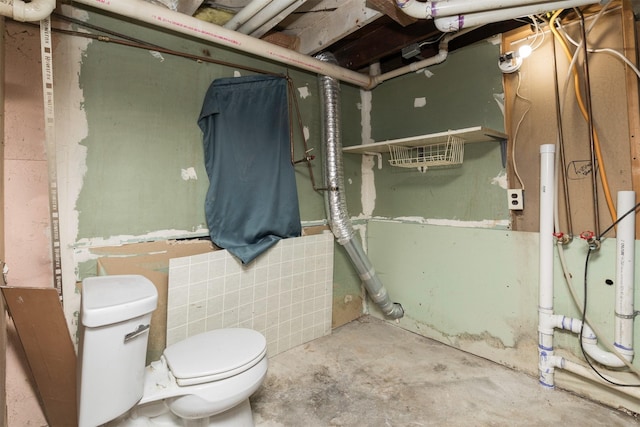 bathroom with concrete floors and toilet