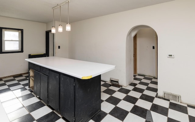 kitchen with hanging light fixtures and a center island