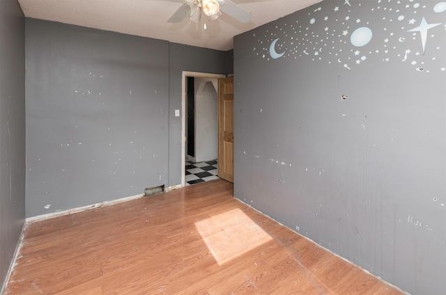 spare room with ceiling fan and light hardwood / wood-style flooring