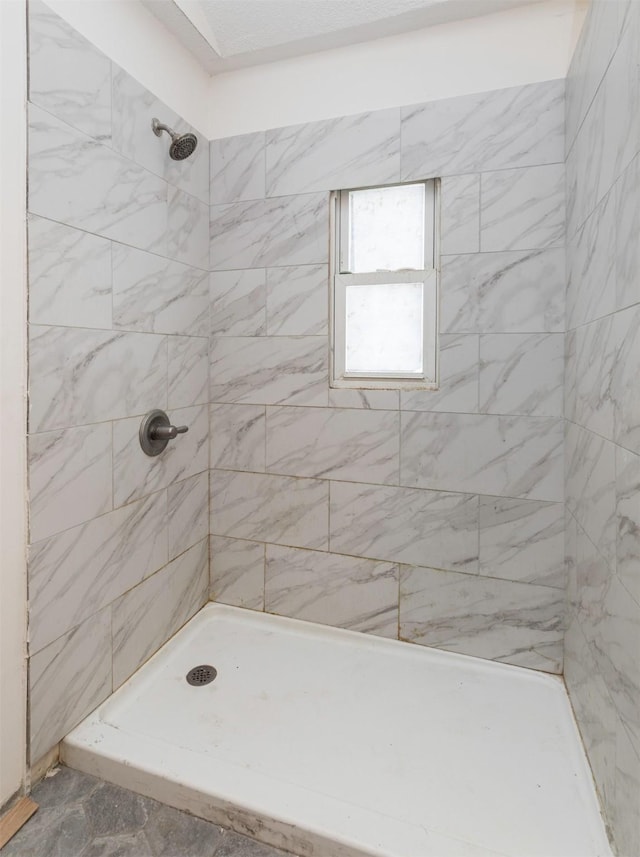 bathroom with a tile shower