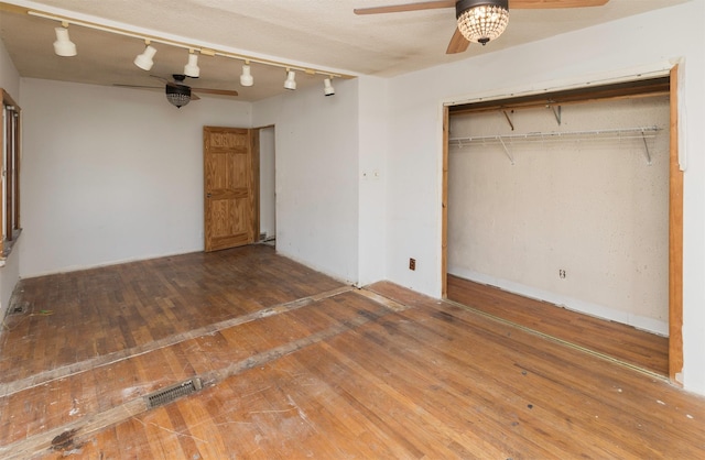 unfurnished bedroom with wood-type flooring and a closet