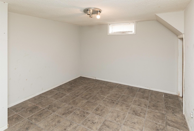 basement featuring a textured ceiling