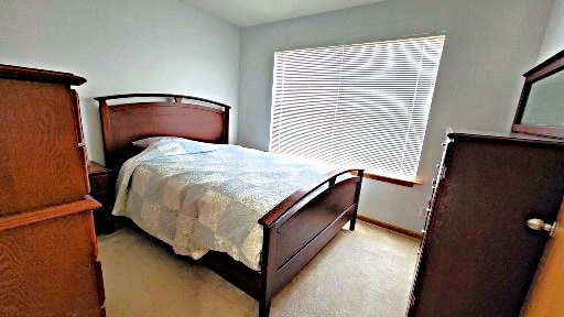 bedroom featuring light carpet