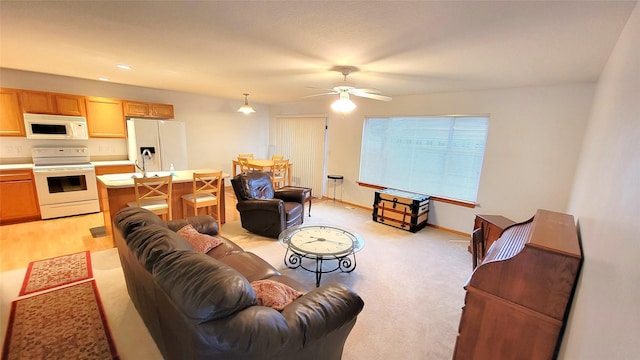 carpeted living room featuring ceiling fan