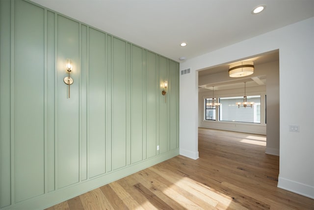 unfurnished room with an inviting chandelier, recessed lighting, visible vents, and light wood finished floors