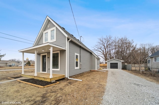 view of front facade with an outbuilding, a garage, and a porch